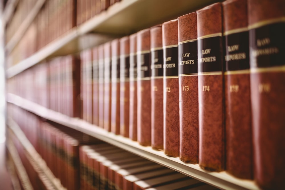 Shelves filled with matching red law report books used by a criminal defense attorney.
